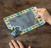 Child drawing on Prehistoric Land Magic Slate
