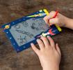 Child drawing on Space Age Magic Slate