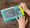 Child drawing on Secret Agent Magic Slate