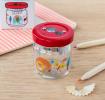 Glass jar pencil sharpener with colourful wild animals print on desk with pencils