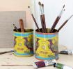 Golden Rose Syrup metal storage tins, one containing paintbrushes, one containing other art tools