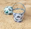 Prehistoric Land tin bucket containing sand alongside play ball and sandcastles