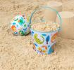 Wild Wonders tin bucket containing sand alongside play ball and sandcastles