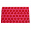 Coir doormat with red spots on pink surface
