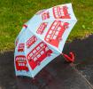 A children’s umbrella featuring red double-decker buses.