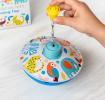 Colourful spinning top toy with a box in the background