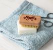 wooden nail brush featuring a butterfly illustration