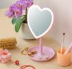 Heart-shaped LED vanity mirror on a stand with accessories