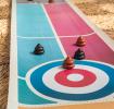 Curling game board with colourful target and brown poop-shaped pieces