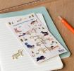 dog-shaped paper clips on a book