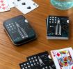 space-themed playing cards beside metal tin box