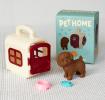 pet carrier with brown dog and a product box in the background