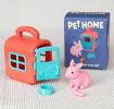pet carrier with pink rabbit and packaging box in the background