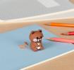 bear shaped pencil sharpener with coloured pencils placed beside 