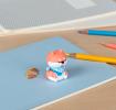 Dog pencil sharpener with coloured pencils placed beside