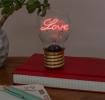 Love usb light bulb placed on a book with light on
