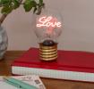 Love usb light bulb placed on a book with light on