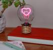 Heart usb light bulb placed on a book with light on
