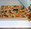 Colourful doormat featuring various dogs in different poses and colours 