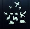 Various glowing dinosaur species on a black background