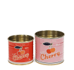 Two vintage-style cherry-themed storage tins, one small red and one larger pink