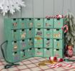 Green advent calendar with 24 numbered drawers and dogs