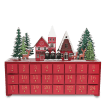 Wooden advent calendar with 24 red drawers numbered in gold, featuring snow-covered houses, trees, and reindeer