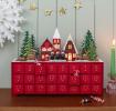 Red advent calendar with 24 gold-numbered drawers and a snowy village scene on top