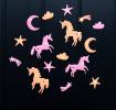 Assorted glow-in-the-dark unicorn featuring stars, moons, and clouds on a black background