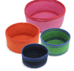 Four woven storage baskets in varying sizes and colours