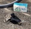 Cyclist multi-tool set with various attachments placed beside a bicycle wheel and a box