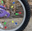 bicycle wheel with colourful lightning bolt-shaped spoke decorations