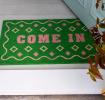 doormat featuring come in print with green background