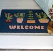 Colourful doormat featuring different pot of plant and welcome letter print