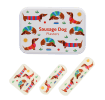 Sausage dog-printed plasters placed beside a matching storage tin featuring sausage dog illustrations