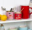 Two mini storage tins used as utensil holder 