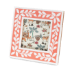 Square pink picture frame with white leaf patterns on the border.
