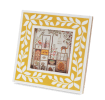 Square picture frame with white leaf patterns and mustard yellow colour on the border.