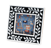 Square picture frame with white leaf patterns and navy blue colour on the border.