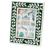 picture frame with a green border and white leaf patterns