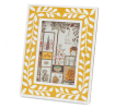 picture frame with a mustard yellow border and white leaf patterns