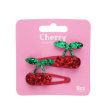Pair of red glitter cherry hair clips with green glitter leaves in packaging