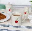 Stoneware mug featuring cherry print with handle 
