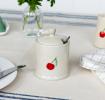 stoneware sugar pot with lid on, featuring a red cherry print and a small handle on top