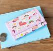 Wallet in pink featuring colourful illustrations of unicorns, rainbows and stars 