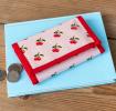 Wallet in pink featuring colourful illustrations of red cherry print 