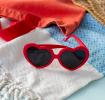 Heart-shaped funglasses with red frames and dark lenses