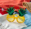 Pineapple-shaped funglasses with yellow textured frames, round yellow lenses, and green leaf accents.