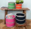 Four woven storage baskets in varying sizes and colours