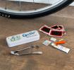cyclist puncture puncture repair kit beside a storage tin